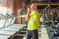 Portrait of athletic middle aged man in sportswear doing stretching exercises, warming up before workout in a gym or Royalty Free Stock Photo