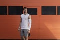 Portrait athletic, muscular man preparing for warming up with jumping rope