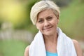 Portrait of athletic senior woman relaxing after jogging