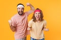 Portrait of athletic young couple screaming and clenching fists in triumph