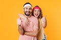 Portrait of athletic young couple smiling and gesturing thumbs up Royalty Free Stock Photo