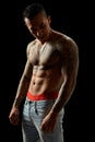 Portrait of athletic young tattooed guy. Studio shot, isolated Royalty Free Stock Photo