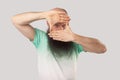 Portrait of attentive middle aged bald man with long beard in light green t-shirt standing with crop composition gesture and Royalty Free Stock Photo