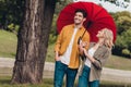 Portrait of attractive adorable flirty amorous cheerful couple meeting spending weekend using parasol outdoors Royalty Free Stock Photo