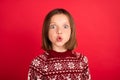 Portrait of attractive amazed cheerful girl wearing festal pullover pout lips isolated over bright red color background Royalty Free Stock Photo
