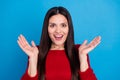 Portrait of attractive amazed cheerful lucky woman clapping palms isolated over bright blue color background