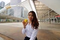 Portrait of attractive Asian business woman with yellow ball in the city background. Royalty Free Stock Photo