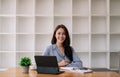 Portrait Attractive Asian Businesswoman working with smart tablet on wooden desk at her office Royalty Free Stock Photo