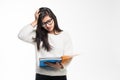 Portrait of attractive asian indian student woman standing holding reading a book with upset mood over white background. Education Royalty Free Stock Photo