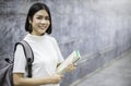 Portrait of attractive asian student girl standing holding books. Royalty Free Stock Photo