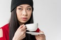 Portrait of attractive asian woman holding tea cup isolated Royalty Free Stock Photo