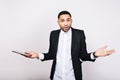 Portrait attractive astonished guy in white shirt and black jacket with tablet on white background. Fashionable