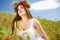 Portrait of an attractive beautiful girl in a poppy field Royalty Free Stock Photo