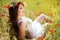 Portrait of an attractive beautiful girl in a poppy field Royalty Free Stock Photo