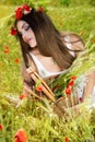 Portrait of an attractive beautiful girl in a poppy field Royalty Free Stock Photo