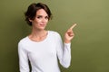 Portrait of attractive beautiful promoter lady directing finger empty space shopping adv ads ad isolated khaki green Royalty Free Stock Photo