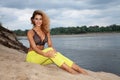 Portrait of attractive blonde girl in black bra and yellow pants Royalty Free Stock Photo