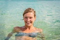 Portrait of an attractive blonde woman with blue eyes in clear blue water Royalty Free Stock Photo