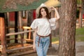 Teen girl standing leaning against tall tree in country estate in summer Royalty Free Stock Photo