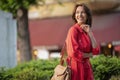 Portrait of a smiling brown haired woman standing on the street Royalty Free Stock Photo