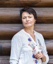 Portrait of an attractive brunette woman against a wooden wall