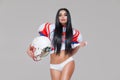 Portrait of attractive brunette female american football player in uniform and jersey T-shirt posing with helmet Royalty Free Stock Photo