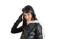 Portrait of an attractive brunette girl in retro pilot costume giving military salute Royalty Free Stock Photo