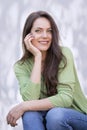 Portrait of an attractive brunette haired woman relaxing at white background outside Royalty Free Stock Photo