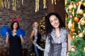 Portrait of attractive brunette woman on New Year`s party near decotated Christmas tree