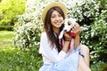 Attractive hipster young woman went for a walk in the park, playing with cute jack russell terrier puppy on clear sunny day. Royalty Free Stock Photo