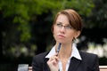 Portrait of attractive business woman with glasses thinking