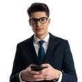 attractive businessman with glasses holding phone and writing a message Royalty Free Stock Photo