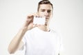 Portrait of attractive businessman holding blank business card, empty space for layout, with white background Royalty Free Stock Photo