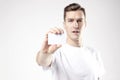 Portrait of attractive businessman holding blank business card, empty space for layout, with white background. Focus on card Royalty Free Stock Photo