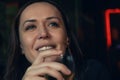 Portrait of attractive Caucasian smiling woman drinking glass of white wine in restaurant in the evening Royalty Free Stock Photo