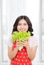 portrait of attractive caucasian smiling woman isolated on kitchen shot eating salat