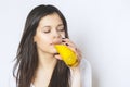 Portrait of attractive caucasian smiling woman isolated on white studio shot drinking orange juice face skin. Portrait of a pretty Royalty Free Stock Photo