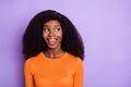 Portrait of attractive cheerful amazed bushy-haired girl looking aside copy space isolated over purple violet pastel