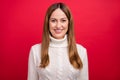 Portrait of attractive cheerful brown-haired woman wearing warm season pullover isolated over bright red color Royalty Free Stock Photo