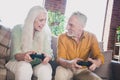 Portrait of attractive cheerful couple sitting on sofa playing game having fun free time at loft industrial interior Royalty Free Stock Photo