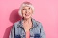 Portrait of attractive cheerful cunning grey-haired woman looking aside copy space isolated over pink pastel color