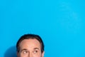 Portrait of attractive cheerful curious brown-haired man looking copy space isolated over bright blue color background Royalty Free Stock Photo