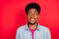 Portrait of attractive cheerful curious brunet guy thinking copy empty space isolated over bright red color background