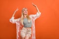 Portrait of attractive cheerful dreamy slim girl dancing having fun isolated over bright orange color background