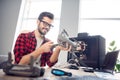 Portrait of attractive cheerful focused skilled guy fixing drone detail security solution at work place station indoors