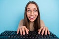 Portrait of attractive cheerful funny girl typing playing strategy game chatting isolated over bright blue color Royalty Free Stock Photo