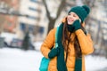 Portrait of attractive cheerful girl calling friend operator strolling free time on fresh air wintertime snowy weather