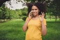 Portrait of attractive cheerful girl talking on phone chatting showing ok-sign good day on fresh air outdoors Royalty Free Stock Photo
