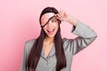 Portrait of attractive cheerful girl touching blindfold waking up peeking having fun party over pink pastel