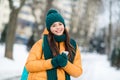 Portrait of attractive cheerful girl using device gadget social network on fresh air wintertime snowy weather outdoors